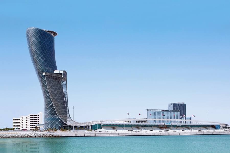 view of capital gate skyscraper from the water