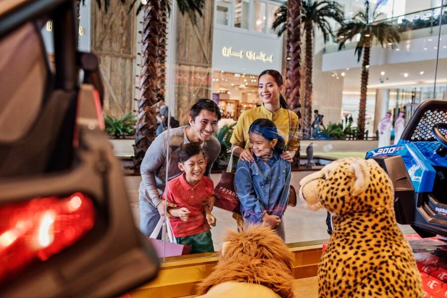 family looking in toy shop window