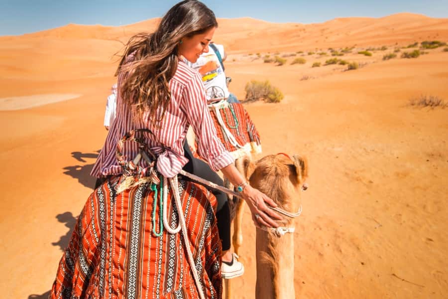 woman on camel in desert