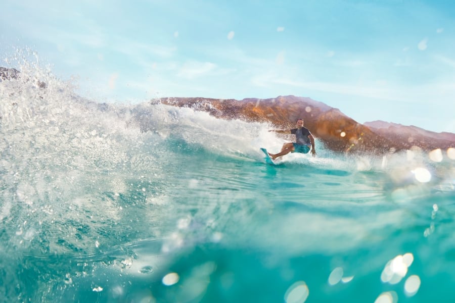 person surfing in clear blue water