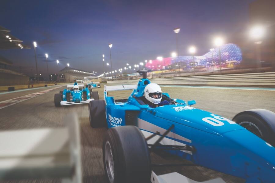 cars racing on yas marina circuit