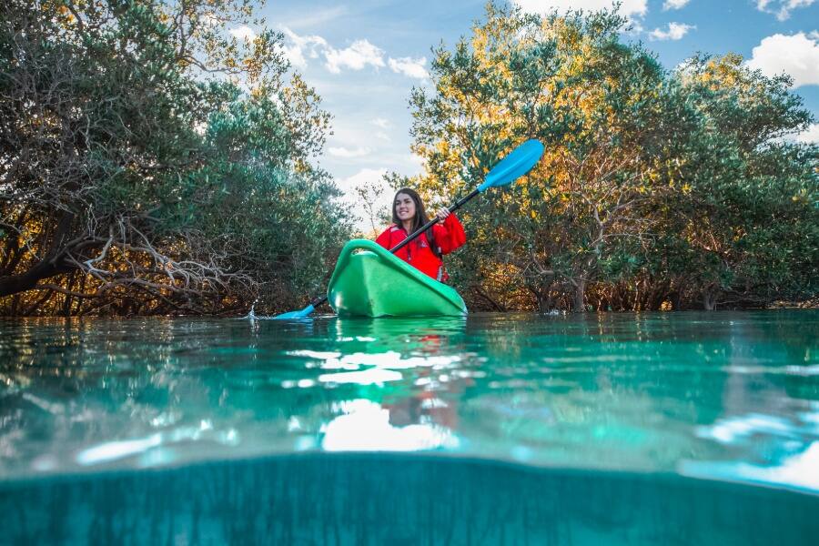 woman kayaking in blue lake