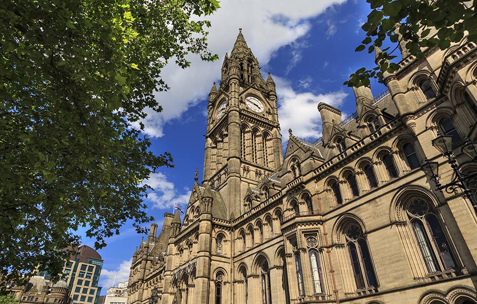 view of manchester town hall with blue skies 