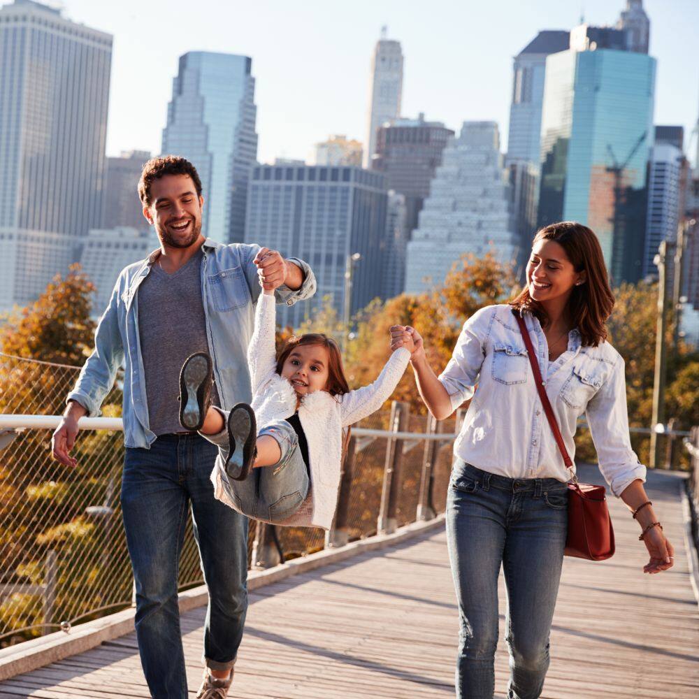 couple walking on a footbridge in new york