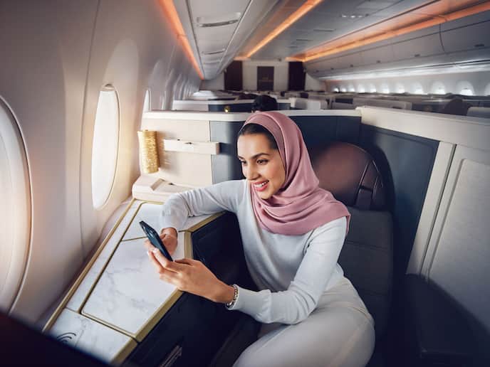 https://www.etihad.com/content/dam/eag/etihadairways/etihadcom/Global/products/etihad-wi-fly/emirati-woman-onboard-wifi.jpg?imwidth=688
