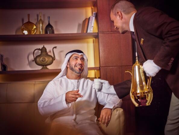emirati male guest enjoying arabic coffee